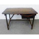 Antique dark oak table of naive construction, the rectangular top with three planks over a single