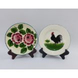 Two Griselda Hill Wemyss Ware pottery plates to include one with a Cockerel and the other with