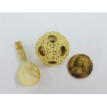 Early 20th century ivory puzzle ball, bone spoon and a small oval plaque depicting a Georgian