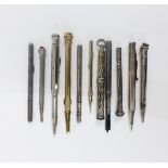A collection of propelling pencils to include two yellow metal, two silver, white metal and a pen