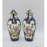 Pair of 19th century porcelain lidded vases painted with figures against a blue scale ground with