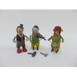 Schuco wind up clockwork monkeys to include one playing a drum, two others with clown faces, one