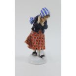 Meissen porcelain figure of girl, modelled standing shielding from a snowball, with blue crossed