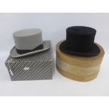 Two vintage top hats to include a black silk hat by Dunn & Co and a grey top hat by Moss Bros,