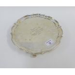 Silver salver with pie crust border and four scroll feet, with inscription to centre, Birmingham