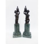 Pair of French bronze figures of putti, each modelled with a covered urn on their shoulder, on green