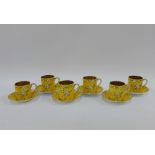 Early 20th century yellow glazed set of six coffee cans and saucers, painted with white blossom