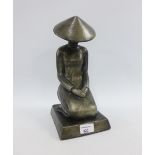 Grey glazed terracotta figure of a seated woman, on a plinth base, 32cm