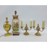 A pair of brass twin light table lamps and another brass table lamp with mask heads and a Japanese