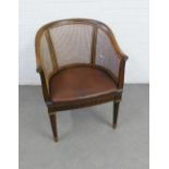 Louis XV style bergere tub chair with upholstered stuff over seat, parcel gilt greek key frieze
