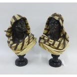 Pair of late 19th century Koeln polychrome painted busts of a Moor and companion, on socle bases,