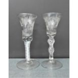 Two Georgian style soda glasses with spiral twist stems and with fruit and vine engraved bowls,
