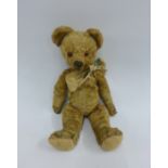 Early 20th century blond mohair Teddy bear with jointed limbs and a stitched nose, 36cm long