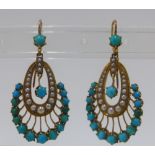 A pair of early 20th century gold drop earrings, each set with turquoise and seed pearls in a fan