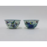 Two Chinese porcelain teabowls, one with a star crack to the inside of the bowl, six character marks