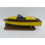 Silver Mist, a hand build model wooden boat with a small diesel engine, on a plinth stand, length