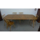 Ercol light elm and beech dining table and set of six stick back chairs (7) 225 (open) x 153 x (