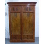 Victorian flame mahogany wardrobe, moulded cornice with fan carving over a pair of doors, with