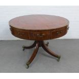 Mahogany drum table with a tooled leather insert and twelve drawers on quadruple legs terminating