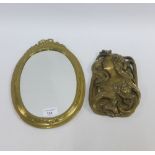 Brass oval framed wall mirror, 35 x 22cm and a Past Times art nouveau wall plaque, (2)