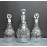 Pair of 19th century decanters with associated stoppers together with another of larger proportions,