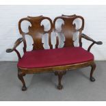 Walnut twin chair back settee, with solid vasiform splat backs, outswept arms with birds head