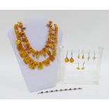 A collection of silver and amber jewellery to include two necklaces, a bracelet and four pairs of