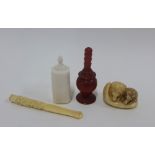 A mixed lot to include an early 20th century ivory box and cover, an okimono, cheroot holder and red