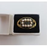 Georgian yellow metal mourning ring with hair compartment within a surround of seed pearls and black
