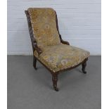 Mahogany framed chair with an upholstered back and seat on turned legs terminating on ceramic