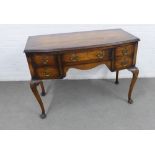 Mahogany and walnut desk / side table, with bow front and four drawers, on shell carved cabriole