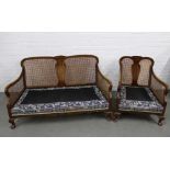 Early 20th century Bergere suite comprising a two seater and an armchair, with loose scatter