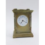 Small brass cased carriage clock with French movement and reeded columns 15cm high including handle