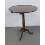 Mahogany tilt top table, the circular dished top on a baluster column with tripod legs, 58 x 71 x