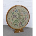 Circular mahogany frame containing a floral embroidered panel, 75 x 67cm