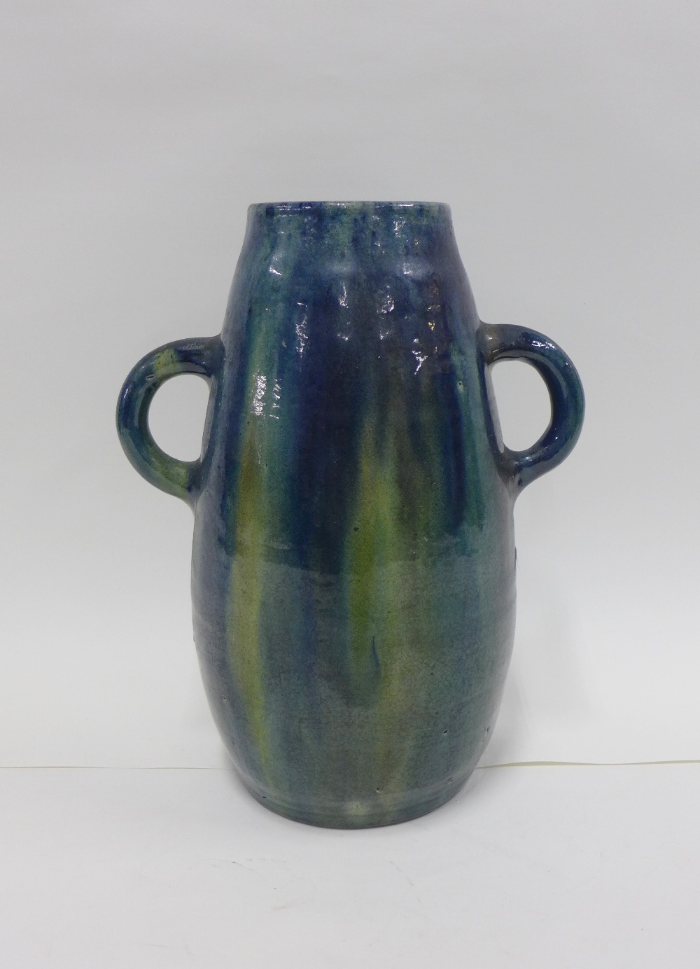Continental art pottery vase with looping handles and a green and blue streaked glaze, 32cm