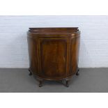 Mahogany bow front cabinet with a ledgeback, single door and shelved interior, on cabriole legs with