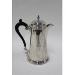 George V silver hot milk pot, of tapering cylindrical form with a stepped circular base, Martin Hall