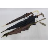 Three late 19th / early 20th century parasols, one with an ivory handle (3)