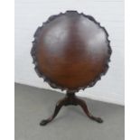 19th century mahogany pie crust table, the tilt top with carved rim, on a reeded baluster column and