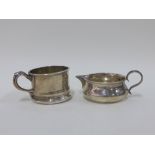 George V silver cream jug, London 1911 together with a silver cup stamped 'Sterling', 5cm high (2)