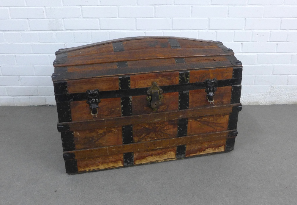 Dome top trunk with oak and metal bound leather outer covering with a lift out tray to the interior,