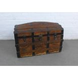 Dome top trunk with oak and metal bound leather outer covering with a lift out tray to the interior,