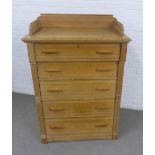 Pine chest of drawers with a ledgeback and five long drawers flanked by a Wellington style lock,