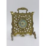 Clock in a pierced brass frame by the British United Clock Company, Reg No. 189583, 19cm