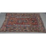 Caucasian rug, red field with pole medallion and multiple geometric borders,