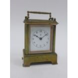 Small brass cased carriage clock with an alarm and bell, 12cm high including handle