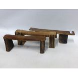 Three Zulu wooden neck rests, longest 46cm (3)