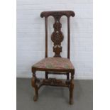 Oak side chair with shaped top rail and flower head carved vertical splat, upholstered seat and