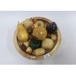 A contemporary wooden fruit bowl with a collection of various wooden fruit (a lot)